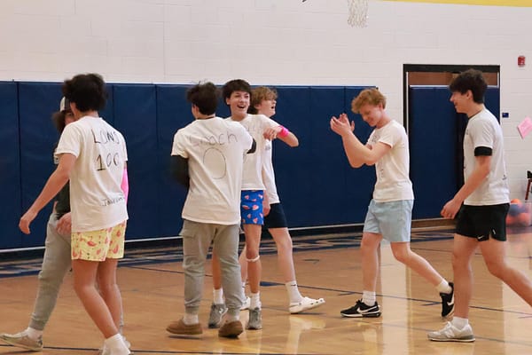 Team captain Dom Marcini celebrates with freshman teammates after their dodgeball victory over the teachers. The dodgeball championship game was played during intervention March 15.