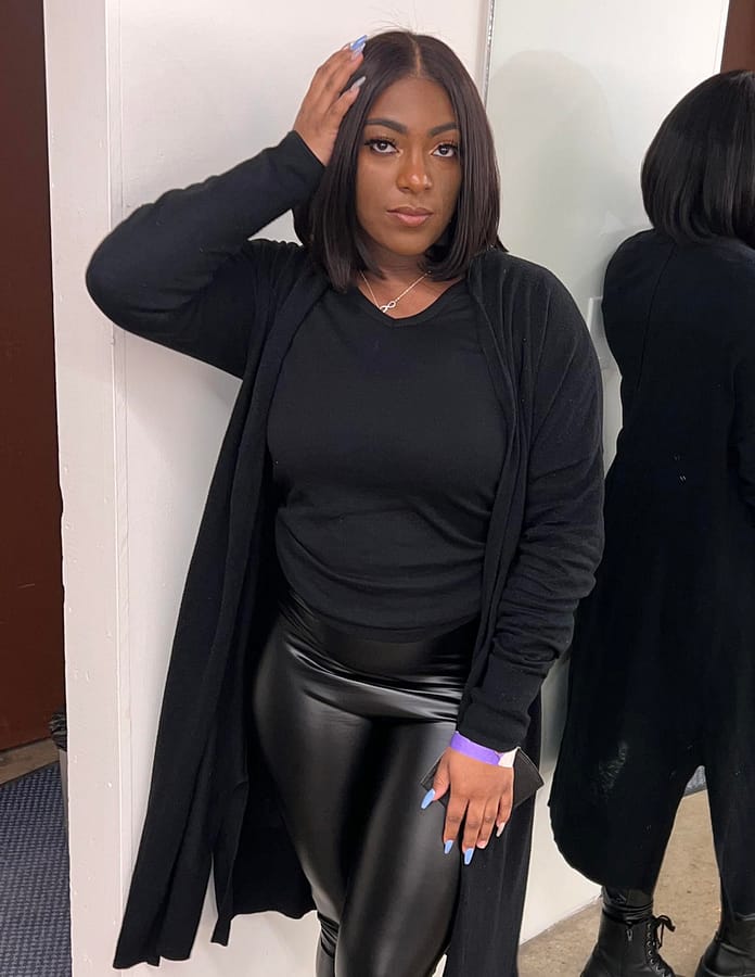 Junior Ryenne Hubbard captures a moment backstage before performing at the The House of Glo fashion show during All-Star Weekend in Cleveland.