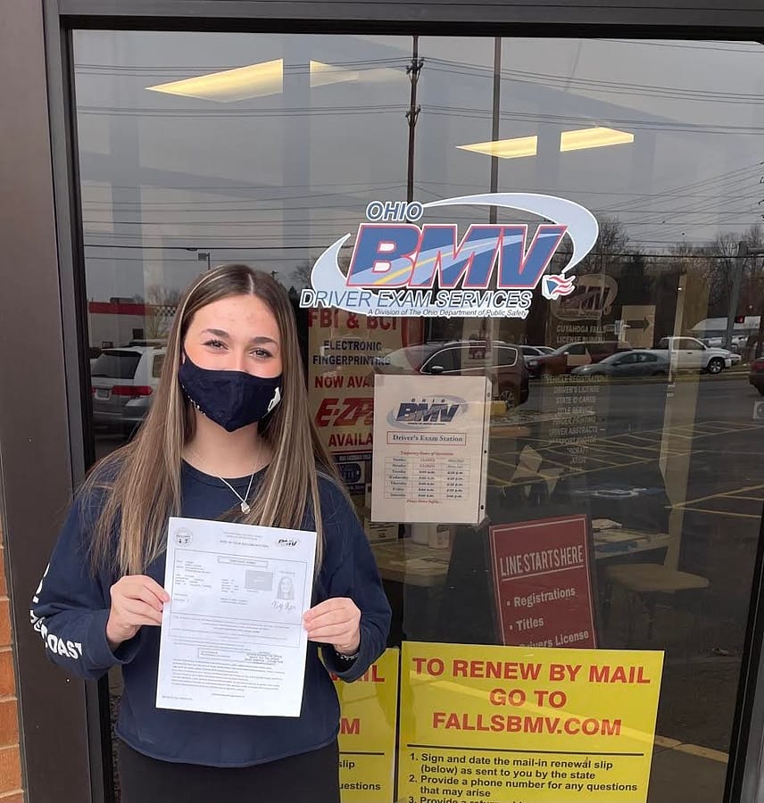 Sophomore+Karly+Reger+holds+her+temporary+permit+in+front+of+the+BMV+January+12.+She+plans+to+take+her+drivers+test+in+July.+
