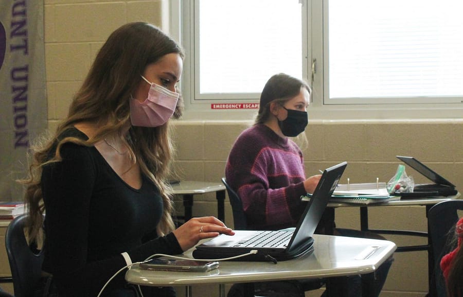 Working+during+ASP+in+Alexandra+Klobusniks+room+are+junior+Aspen+Hanzak+and+sophomore+Megan+Solly.+Both+girls+are+wearing+masks%2C+as+is+the+dress+code+requirement+for+all+students+and+staff+this+school+year+in+an+effort+to+stop+the+spread+of+COVID-19.