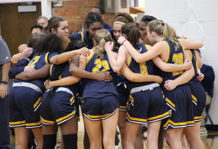 The+Varsity+Rockets+huddle+up+before+their+Jan.+21+game+at+Rootstown.+They+came+away+with+a+51-36+win.