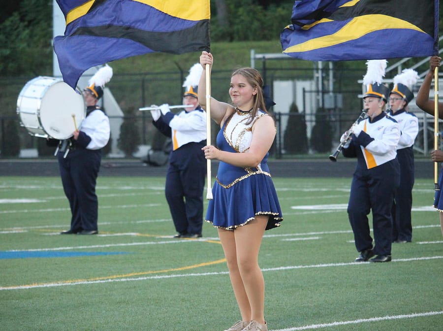Sophomore auxiliary member Miley Anderson performs with fellow bandmates at a football game in the fall. 