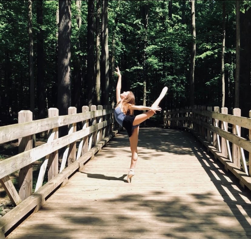 Junior Aspen Hanzak performs an arabesque in the Cleveland Metroparks the summer before eighth grade year. 